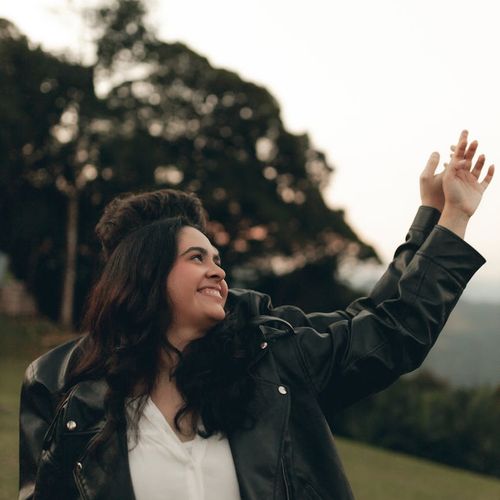 A portrait of a smiling woman in her 30s with a peaceful expression.